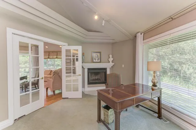 a living room with furniture kitchen view and a large window