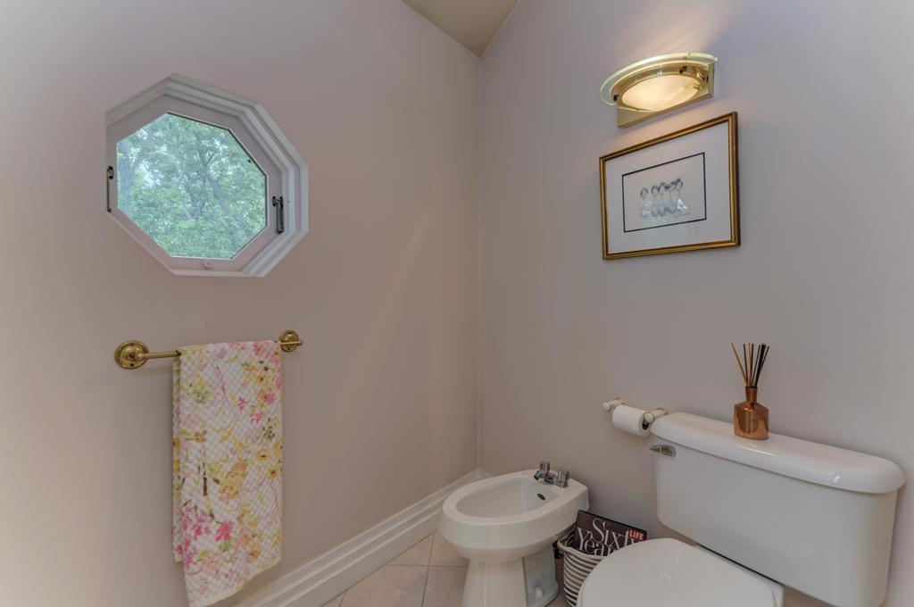 3205 West Southmor Road Morris, IL 60450 - Photo 36 of 74 a white toilet sitting next to a shower curtain