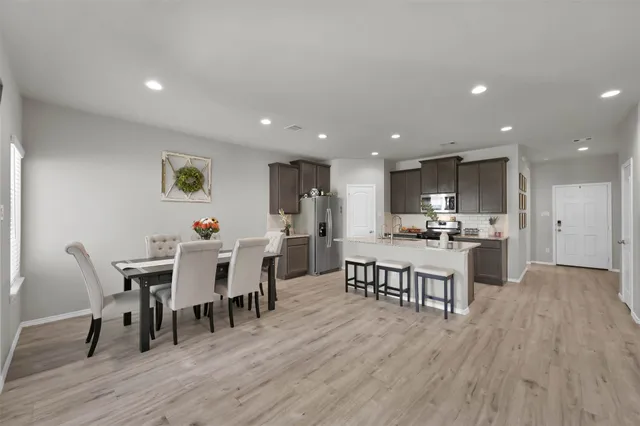 a view of a dining room with furniture and wooden floor