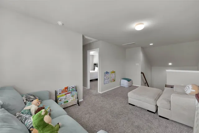 a living room with furniture and white walls
