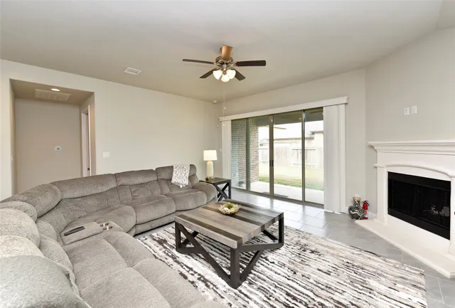 a living room with furniture and a view of dining room