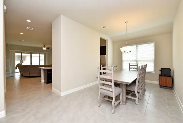 a living room with furniture a fireplace and a chandelier