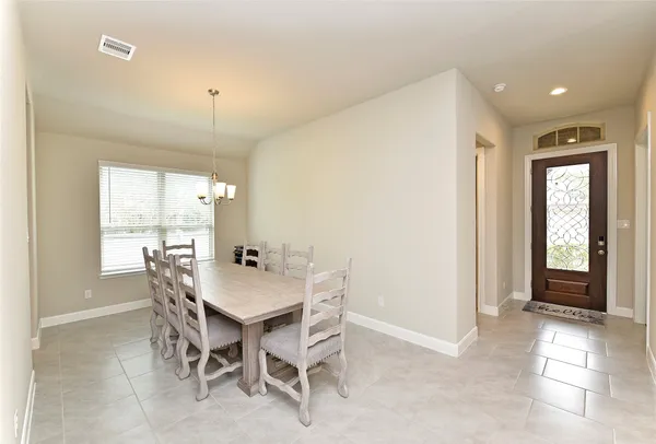 a view of a dining room with furniture and window
