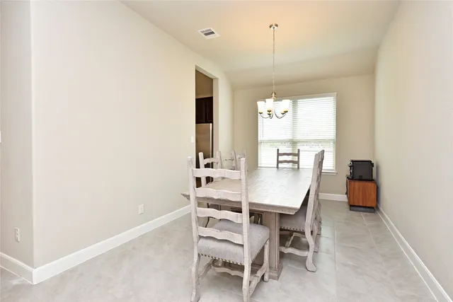 a view of a dining room with furniture and window