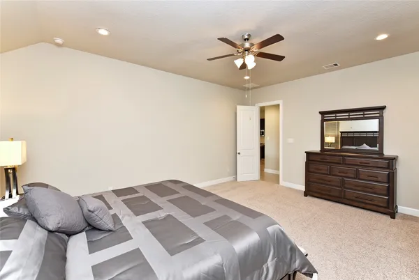 a bedroom with a bed and night stand