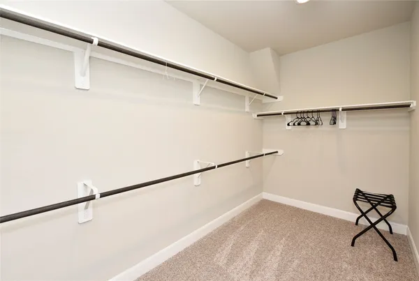 a bathroom with a tub a sink and a large mirror