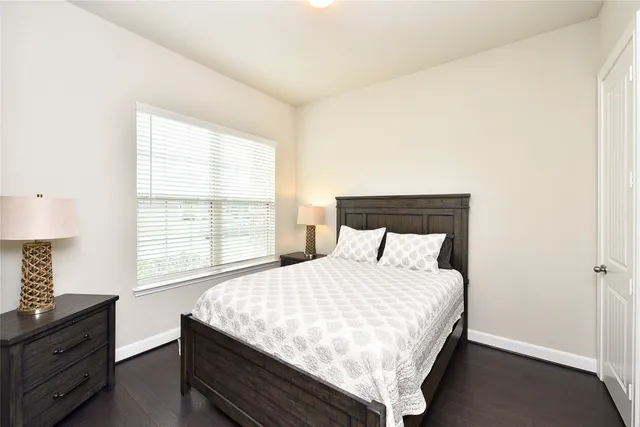 a bedroom with a bed and a large window