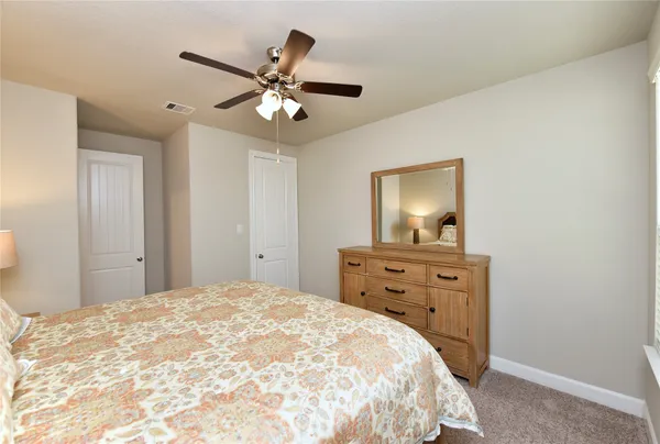 a bedroom with a bed and a night stand