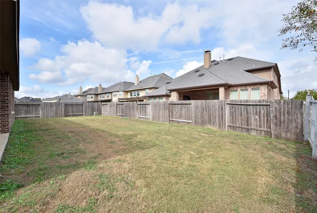 a view of a house with a yard and sitting area