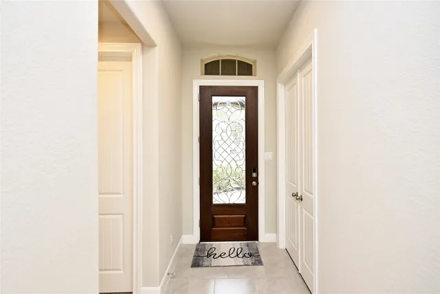 a view of a hallway with a wooden door