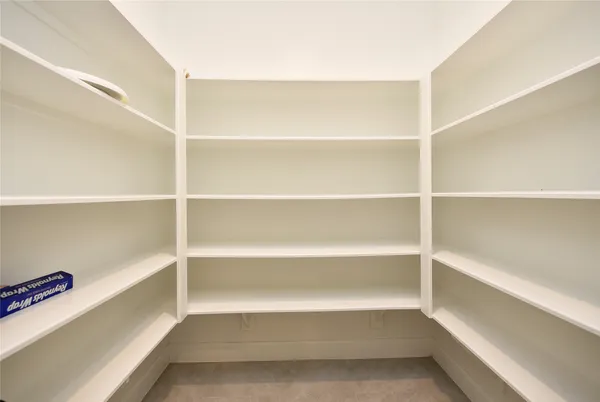 a view of walk in closet with empty racks