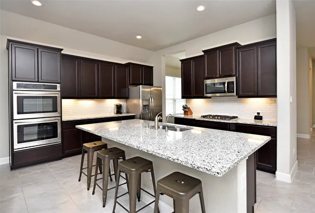 a kitchen with kitchen island cabinets and wooden floor