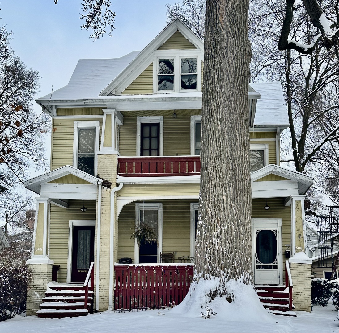 308 East Walnut Street Bloomington, IL 61701 - Photo 1 of 2 a view of a brick house with large windows and a large tree