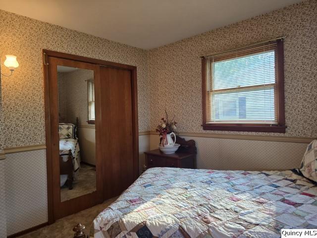 707 Country Lane Carthage, IL 62321 - Photo 16 of 26 a bedroom with a bed and wooden floor
