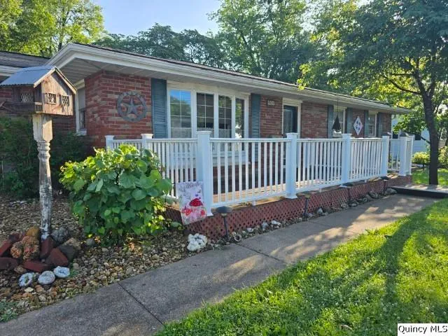 a view of a chair and table in backyard of the house
