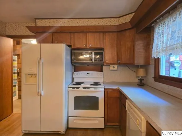 a kitchen with a stove and a refrigerator