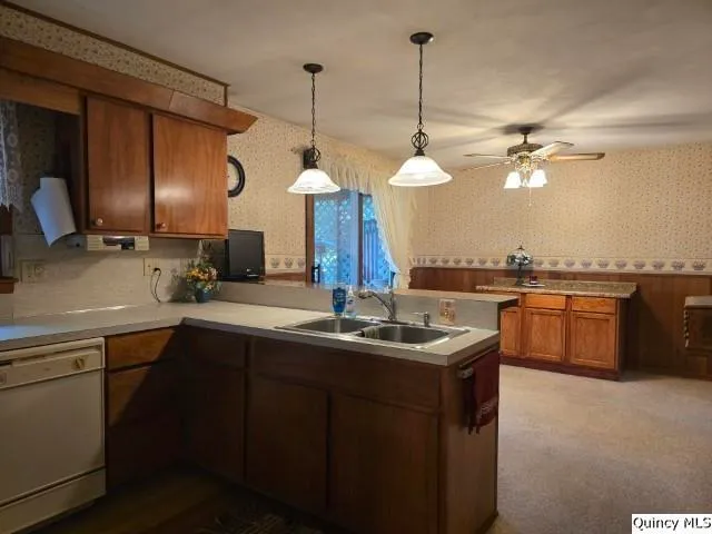 a kitchen with a sink a stove and a chandelier