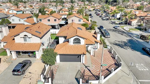 an aerial view of multiple houses with yard
