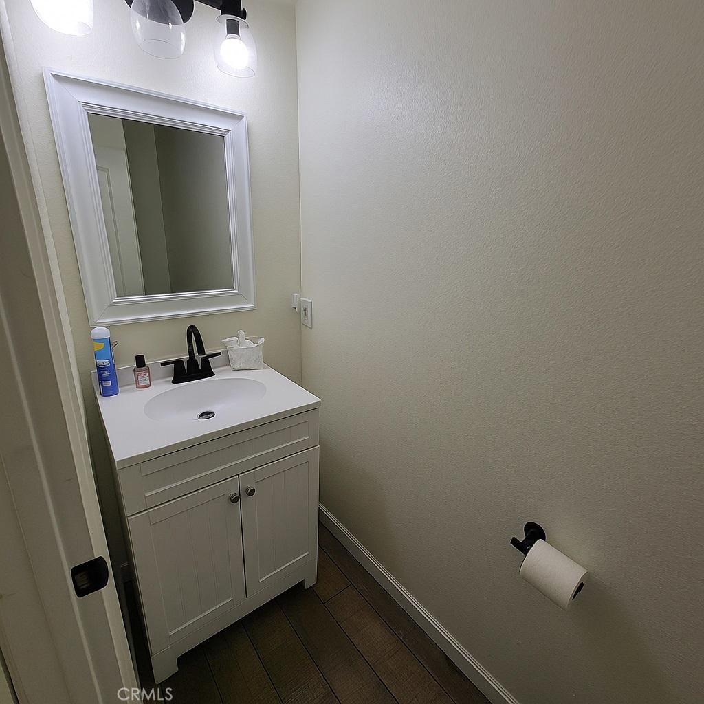 2323 South Cutty Way Anaheim, CA 92802 - Photo 14 of 26 a bathroom with a sink a mirror and vanity