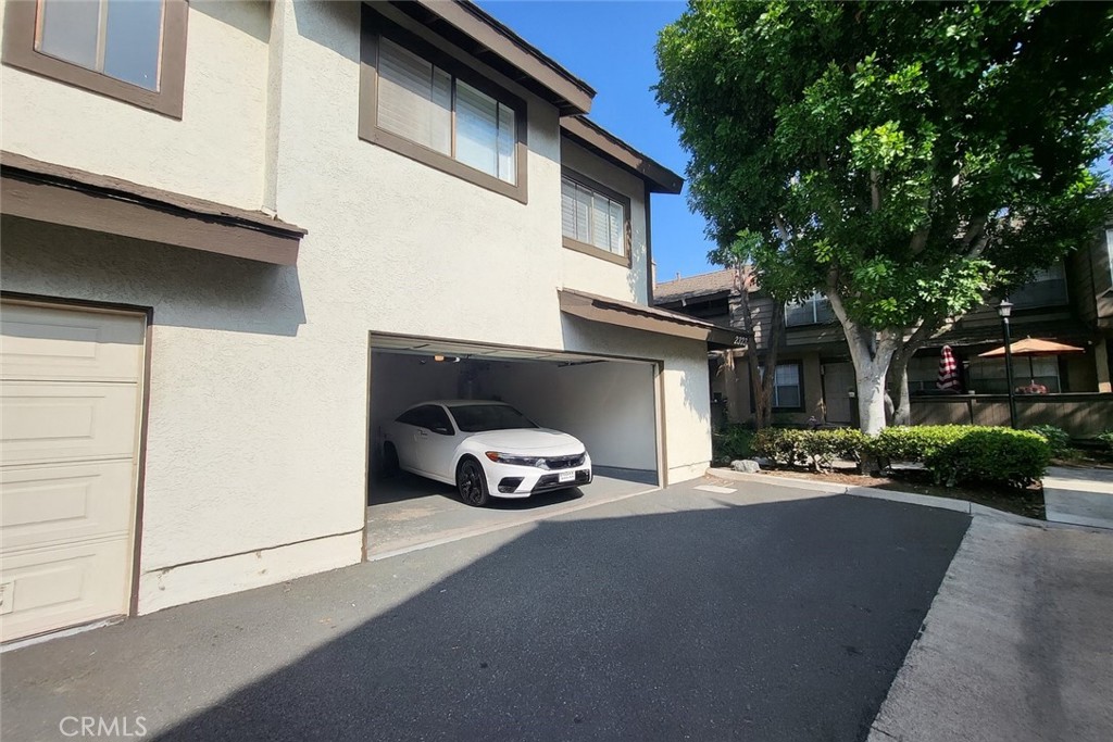 2323 South Cutty Way Anaheim, CA 92802 - Photo 20 of 26 a car parked in front of a white house
