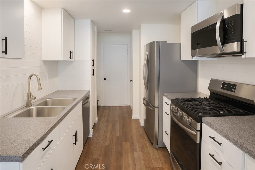 2323 South Cutty Way Anaheim, CA 92802 - Photo 5 of 26 a kitchen with stainless steel appliances granite countertop a sink stove and refrigerator
