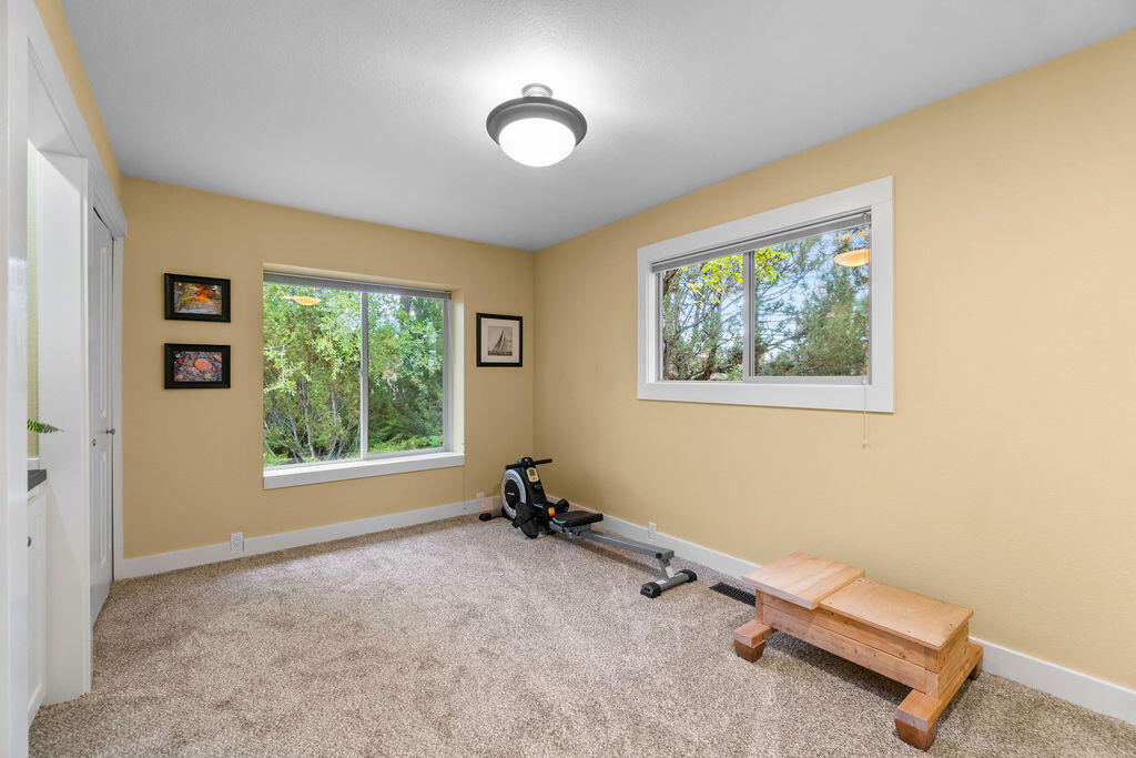 62508 Quail Ridge Road Bend, OR 97701 - Photo 11 of 36 a room with gym equipment and a window