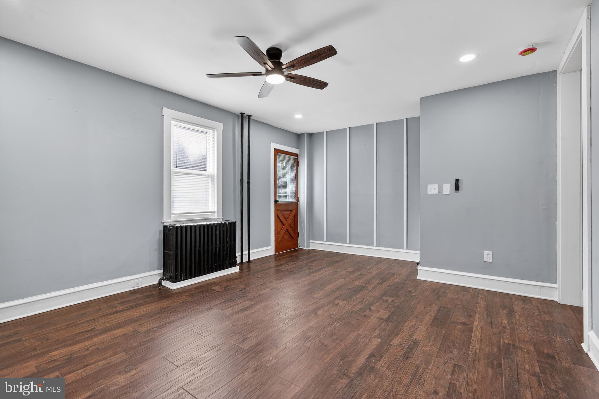223 Noreg Place Brooklawn, NJ 08030 - Photo 11 of 36 an empty room with wooden floor and windows