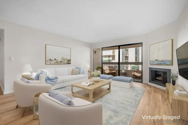 a living room with furniture large window and a fireplace