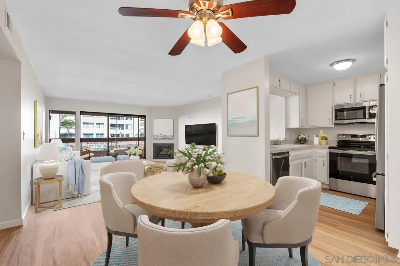 6747 Friars Road, Unit 110 San Diego, CA 92108 - Photo 4 of 24 a kitchen with stainless steel appliances granite countertop a dining table and chairs