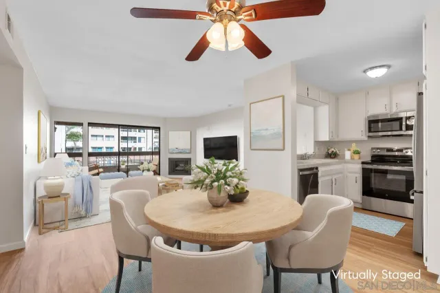 a kitchen with stainless steel appliances granite countertop a dining table and chairs