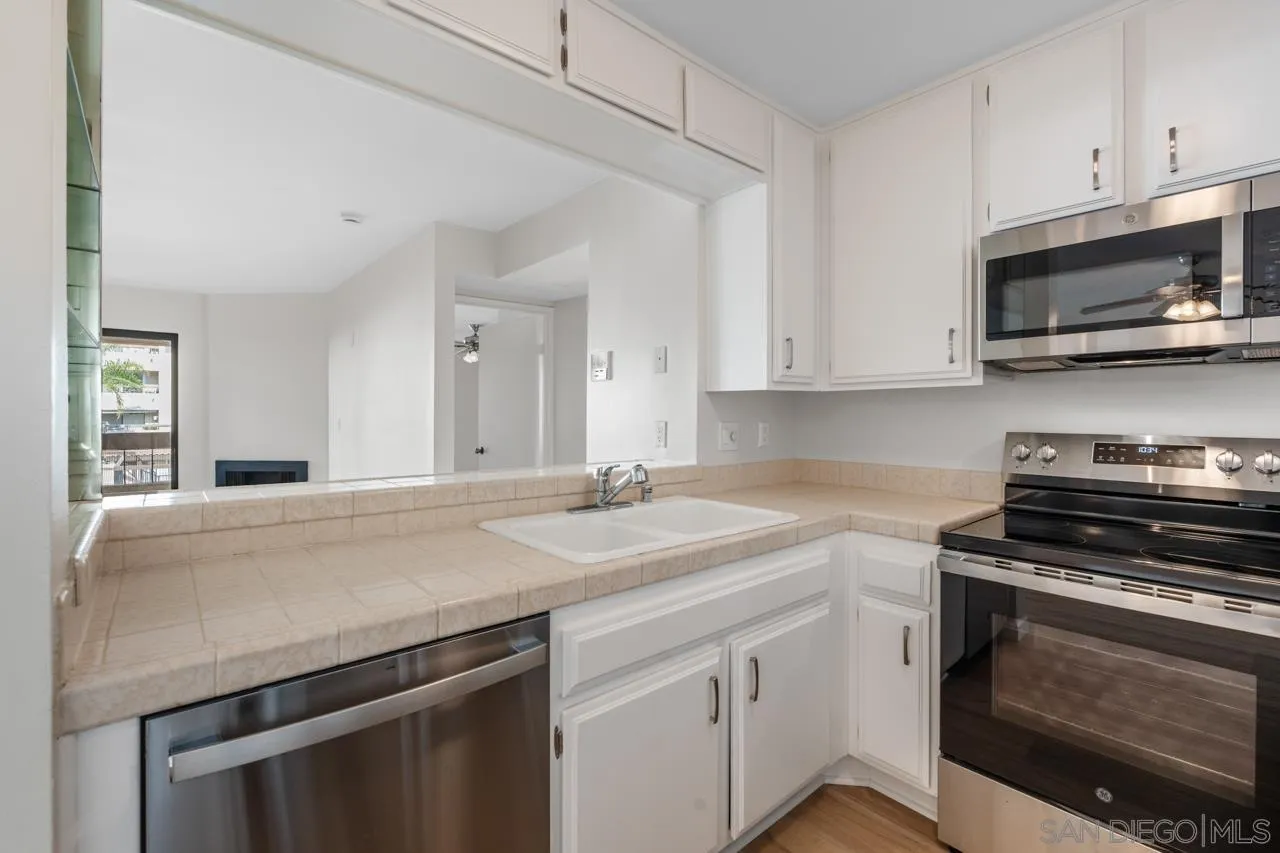 6747 Friars Road, Unit 110 San Diego, CA 92108 - Photo 8 of 24 a kitchen with stainless steel appliances a stove microwave and sink