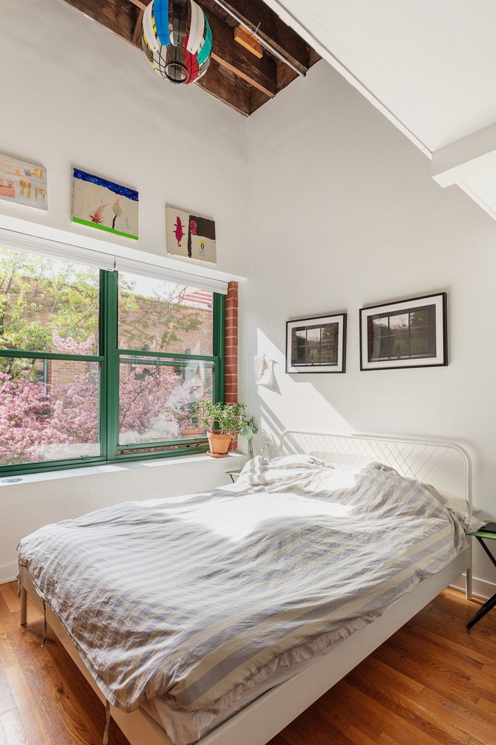 22 North Morgan Street, Unit 215 Chicago, IL 60607 - Photo 14 of 27 a bedroom with a bed and a large window