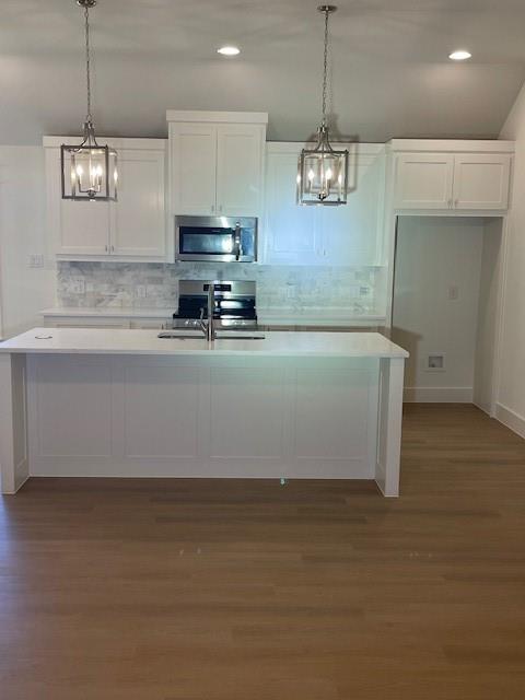 141 Joel Street Springtown, TX 76082 - Photo 9 of 21 a view of a kitchen with stainless steel appliances granite countertop cabinets and a wooden floor