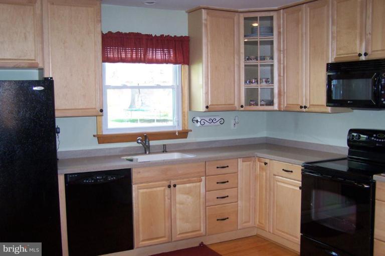 9920 Pepper Hill Road Perry Hall, MD 21128 - Photo 3 of 20 a kitchen with granite countertop a sink cabinets stainless steel appliances and a window