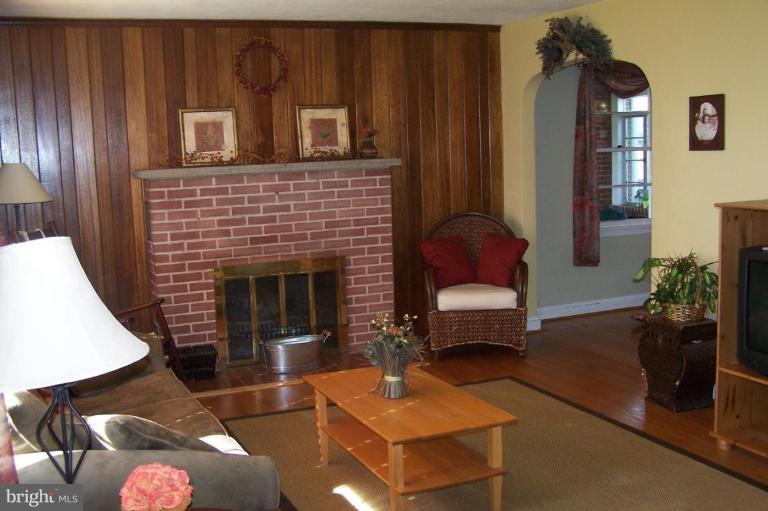 9920 Pepper Hill Road Perry Hall, MD 21128 - Photo 7 of 20 a living room with furniture potted plant and a fireplace