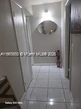 a bathroom with a mirror and vanity