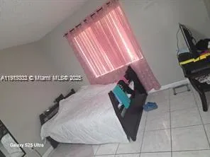 a bedroom with bed and a window