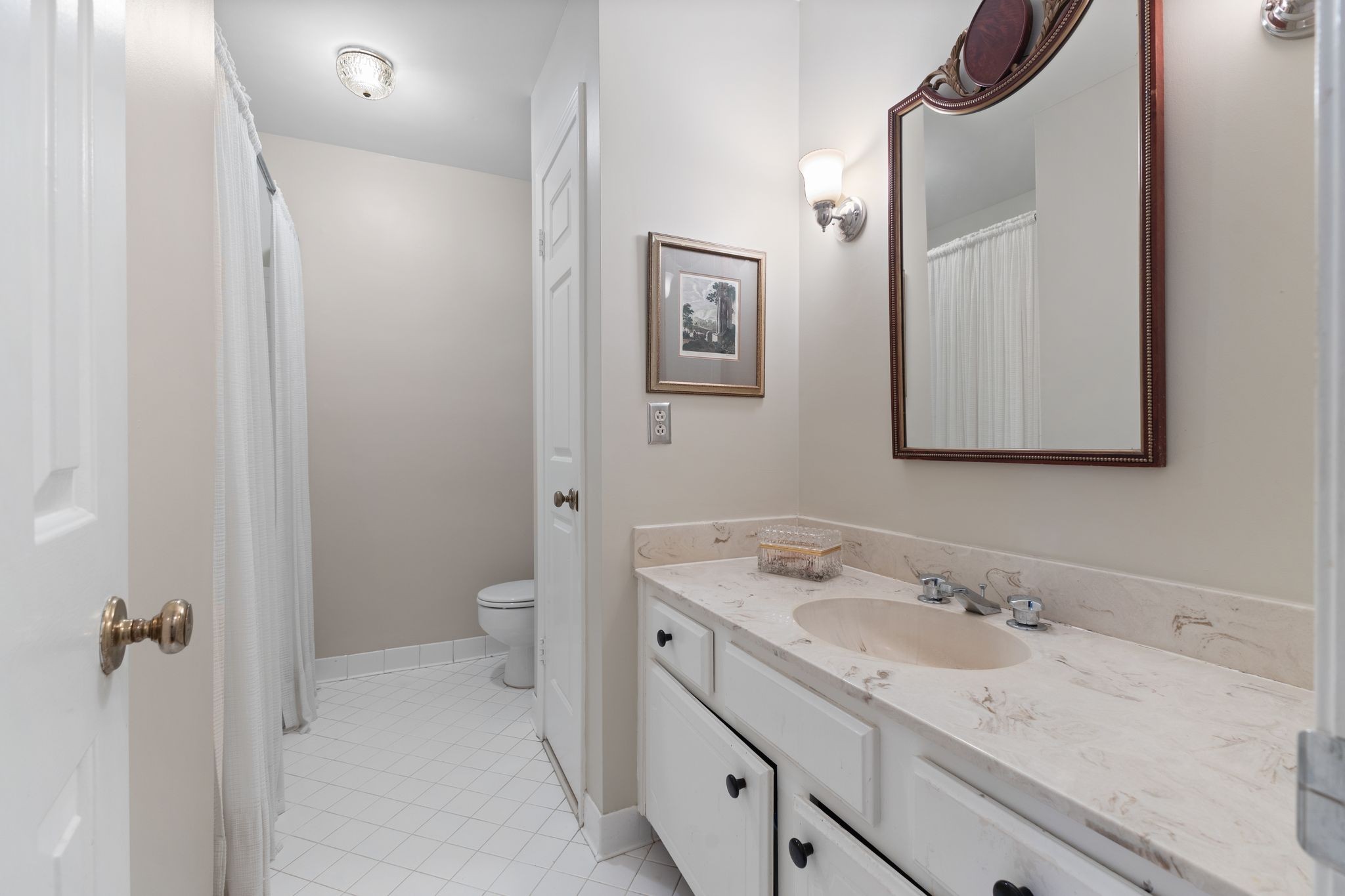 8207 Sawyer Brown Road, Unit M1 Nashville, TN 37221 - Photo 20 of 25 a bathroom with a granite countertop sink toilet and mirror