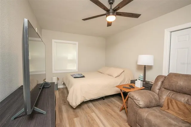 a bedroom with a bed window and a table