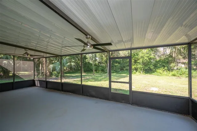 a view of an empty room with large windows