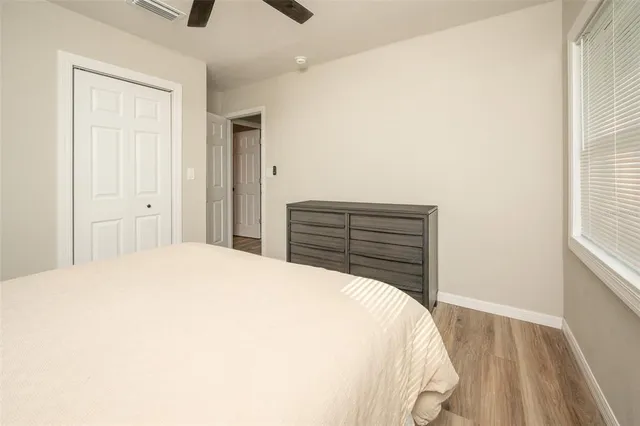 a bedroom with a bed and a window