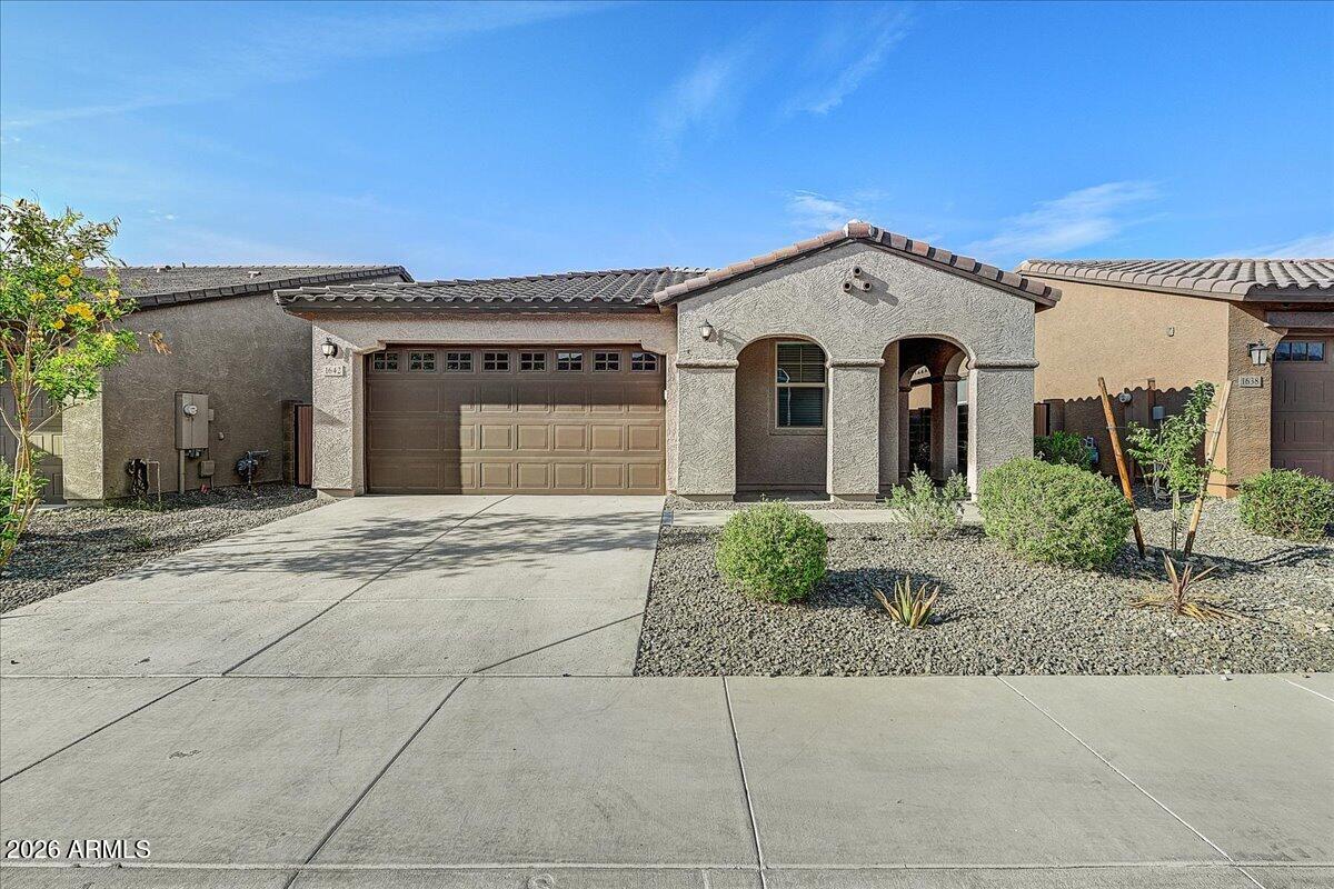 1642 West Monte Way Phoenix, AZ 85041 - Photo 1 of 20 a view of a grey house with a yard