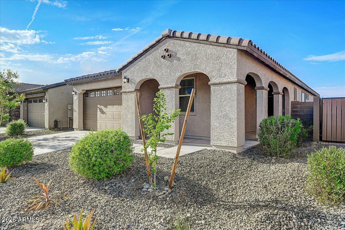 1642 West Monte Way Phoenix, AZ 85041 - Photo 2 of 20 a front view of a house with garden
