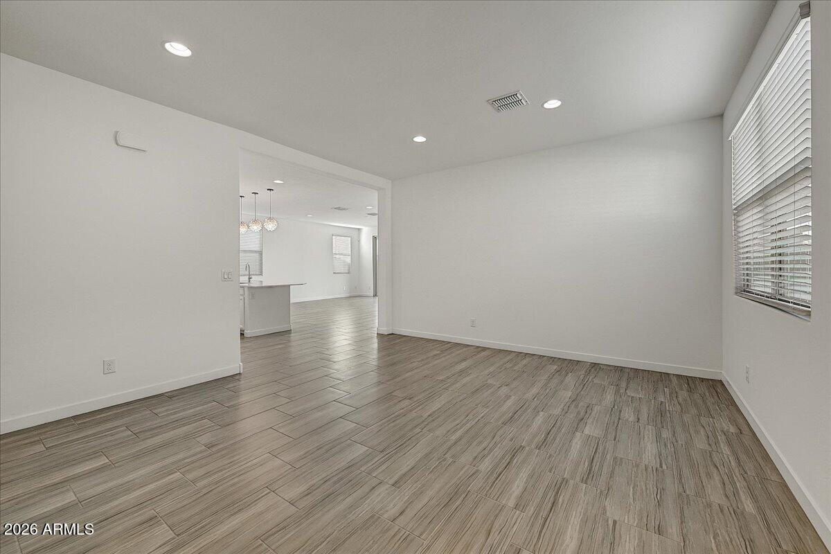 1642 West Monte Way Phoenix, AZ 85041 - Photo 3 of 20 a view of empty room with wooden floor