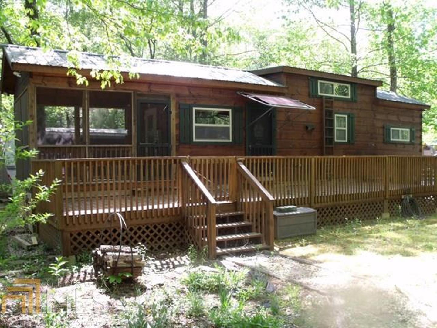 533 Hidden Valley Road, Unit 186 Cleveland, GA 30528 - Photo 1 of 1 a view of a house with a bench in the deck