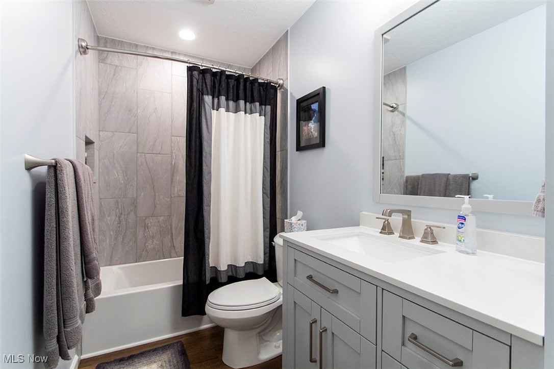 5859 Buffham Road Seville, OH 44273 - Photo 20 of 34 Full bath with vanity, shower / bath combination with curtain, recessed lighting, and wood finished floors