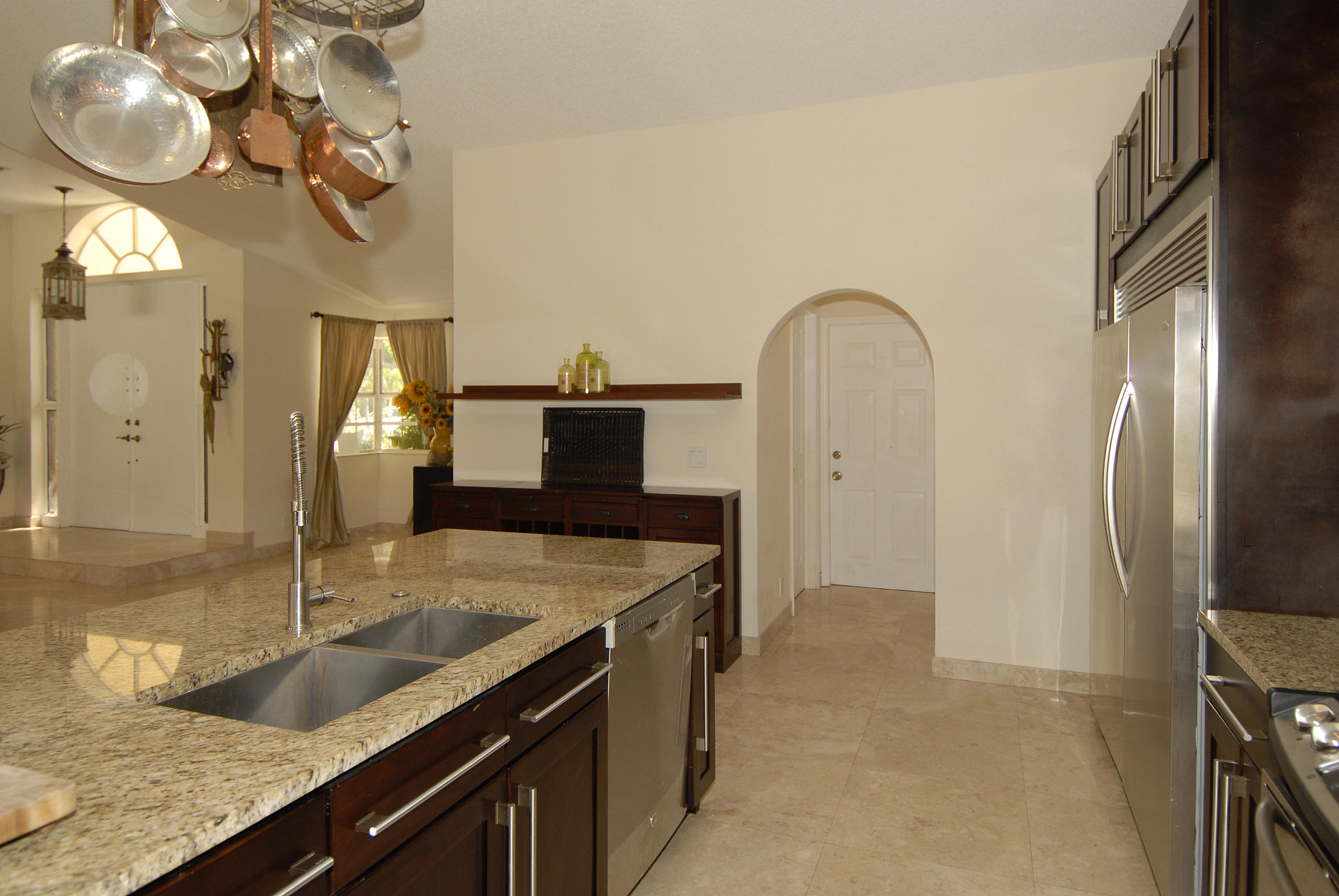 21347 Chinaberry Drive Boca Raton, FL 33428 - Photo 11 of 35 a kitchen with stainless steel appliances granite countertop a sink a refrigerator and a granite counter tops
