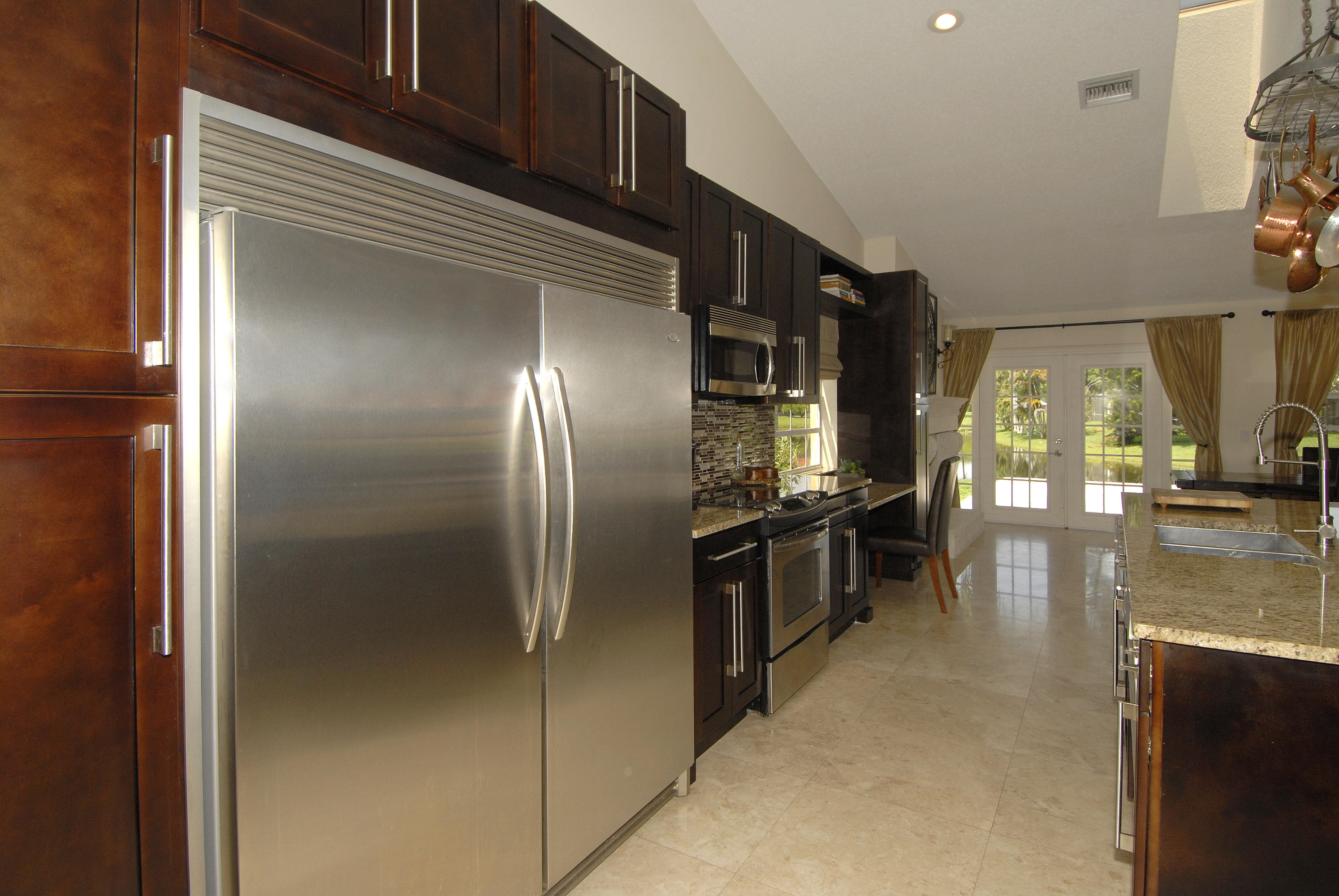 21347 Chinaberry Drive Boca Raton, FL 33428 - Photo 12 of 35 a kitchen with stainless steel appliances granite countertop a refrigerator and a stove