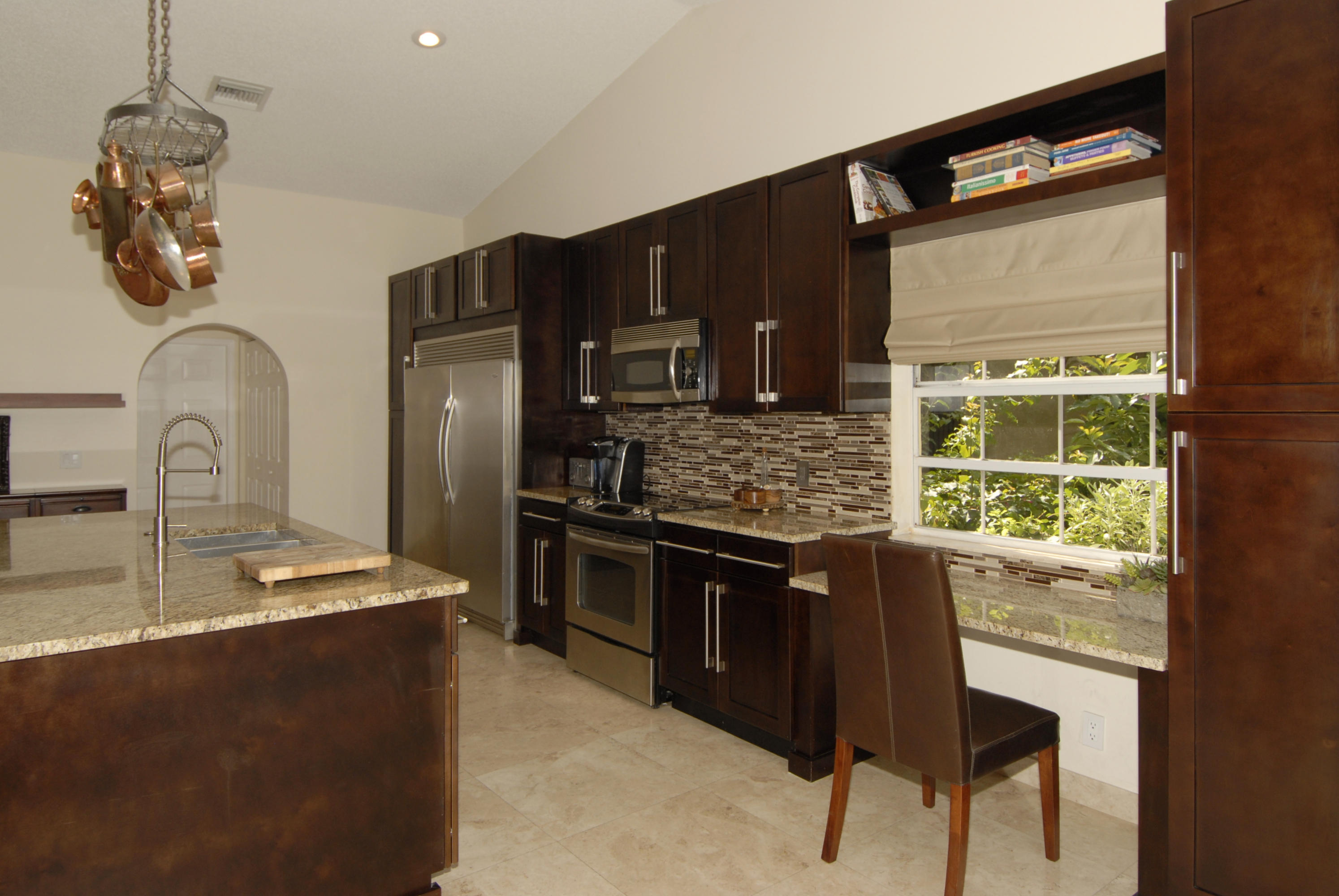 21347 Chinaberry Drive Boca Raton, FL 33428 - Photo 13 of 35 a kitchen with stainless steel appliances granite countertop a sink stove and refrigerator