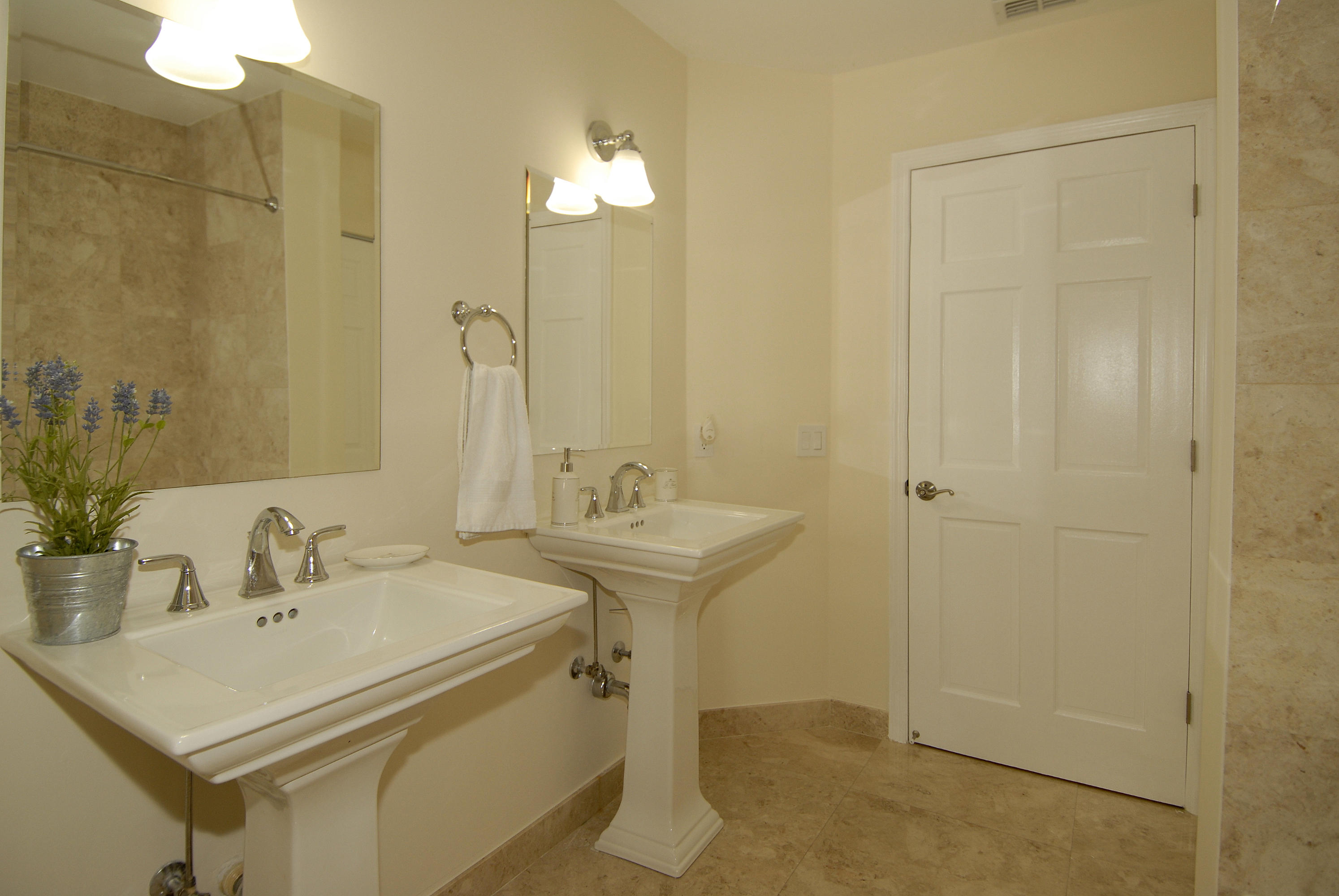 21347 Chinaberry Drive Boca Raton, FL 33428 - Photo 14 of 35 a bathroom with a sink a mirror and a shower